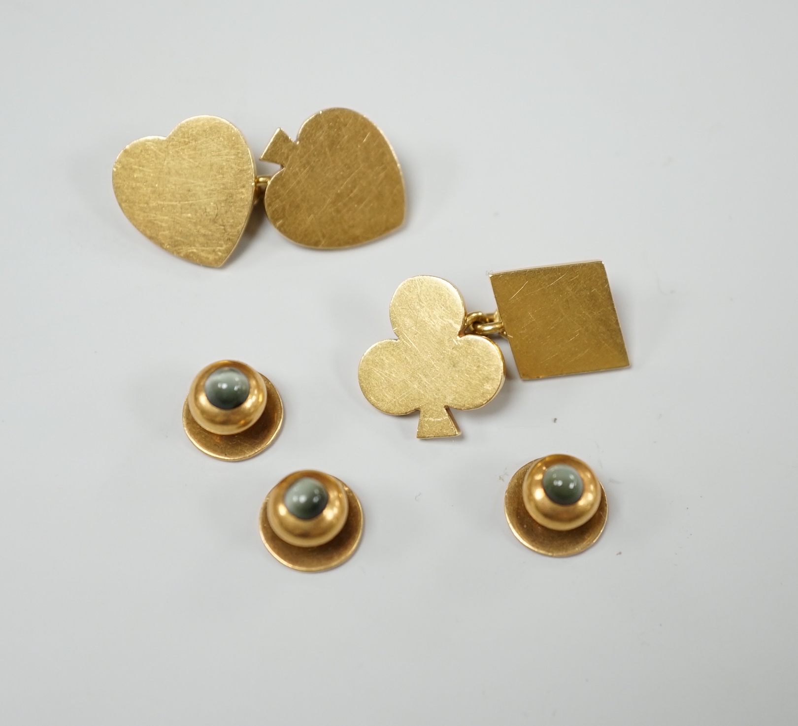 A pair of early 1970's 18ct gold novelty playing card suite cufflinks, 16 grams, together with three yellow metal and cat's eye chrysoberyl set dress studs.